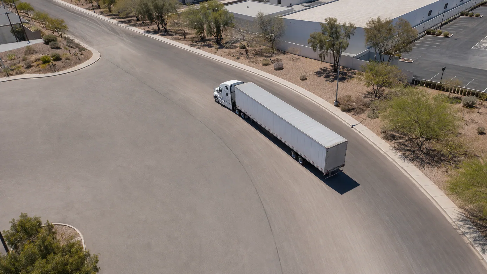 Illustrative overhead view of an unbranded tractor-trailer on a Henderson-area industrial road.